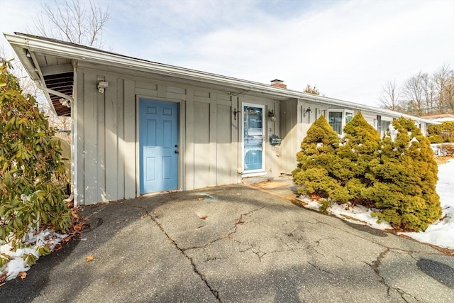 property entrance featuring board and batten siding