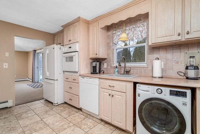 kitchen featuring washer / clothes dryer, light countertops, baseboard heating, a sink, and white appliances