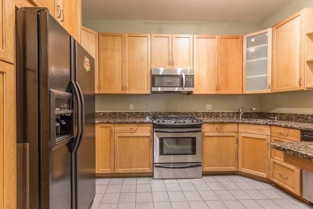 15 Blackwood Unit 2, Boston, MA 02115 - kitchen featuring appliances with stainless steel finishes, a sink, light tile patterned floors, and dark stone countertops
