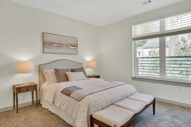 bedroom with carpet and multiple windows