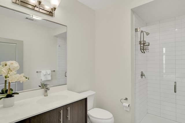 bathroom with a shower with shower door, vanity, and toilet