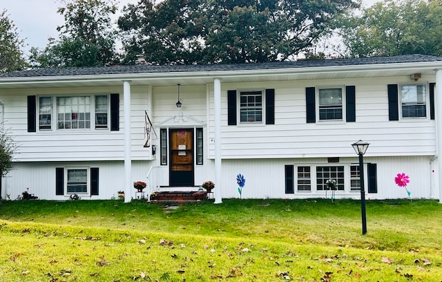 raised ranch featuring a front yard