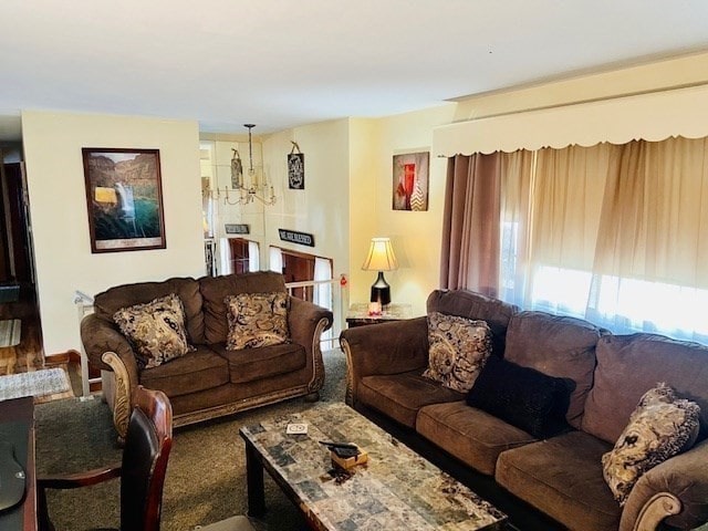 carpeted living room featuring a chandelier