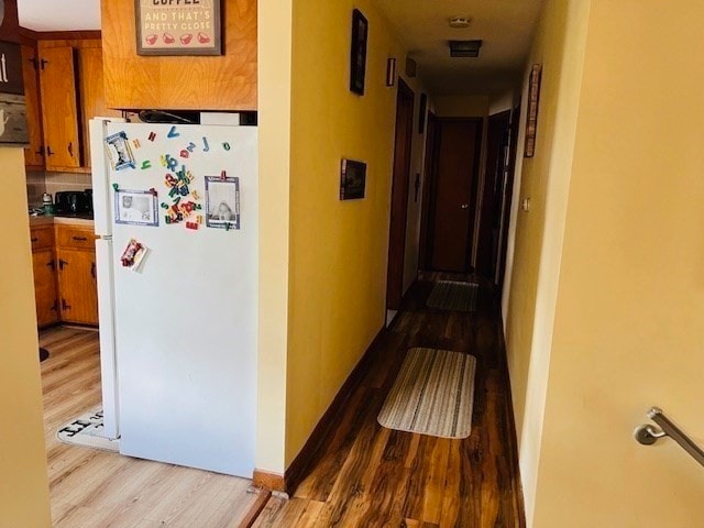 hallway with light hardwood / wood-style flooring