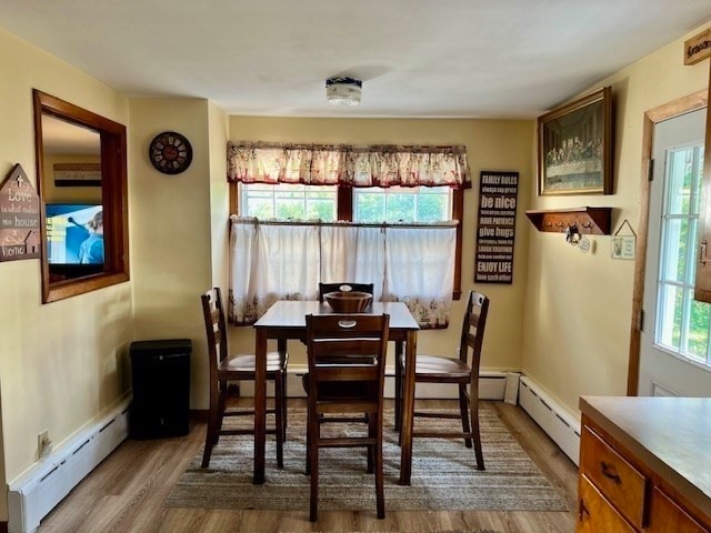 dining room featuring light hardwood / wood-style flooring and baseboard heating