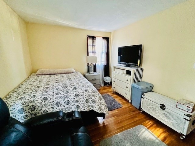 bedroom with dark hardwood / wood-style floors