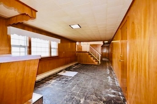 hallway with wood walls