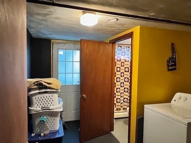 laundry room featuring washer / dryer, a textured ceiling, and a baseboard heating unit