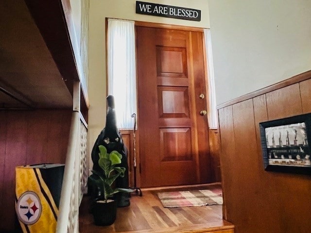 doorway to outside featuring wood walls and wood-type flooring