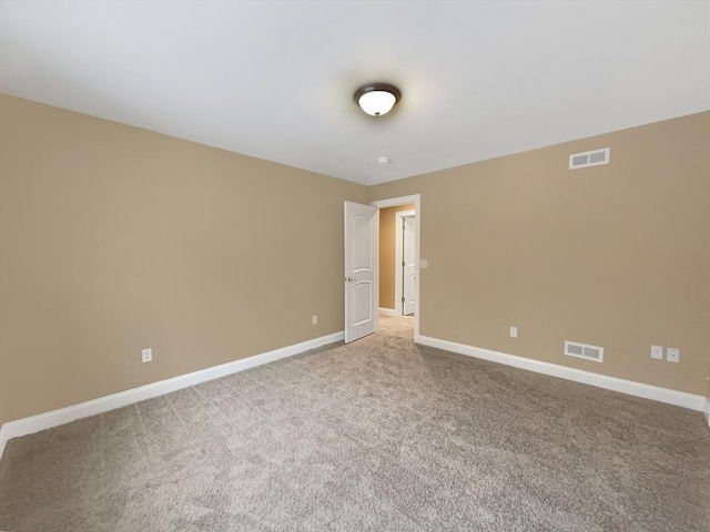 unfurnished room featuring light carpet