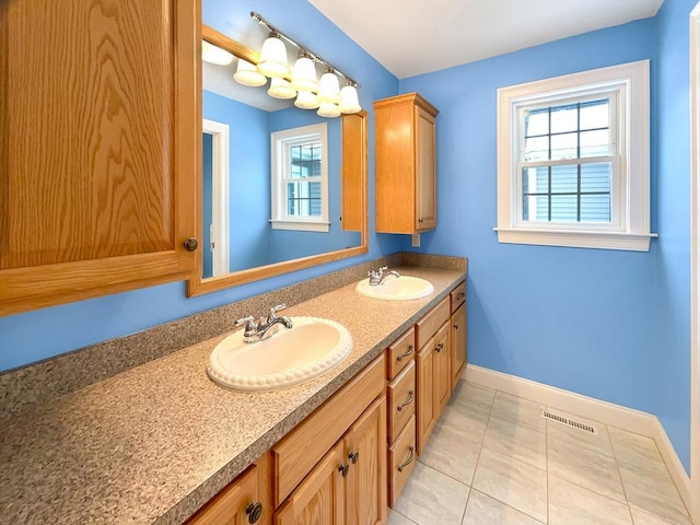 bathroom with tile patterned flooring and vanity