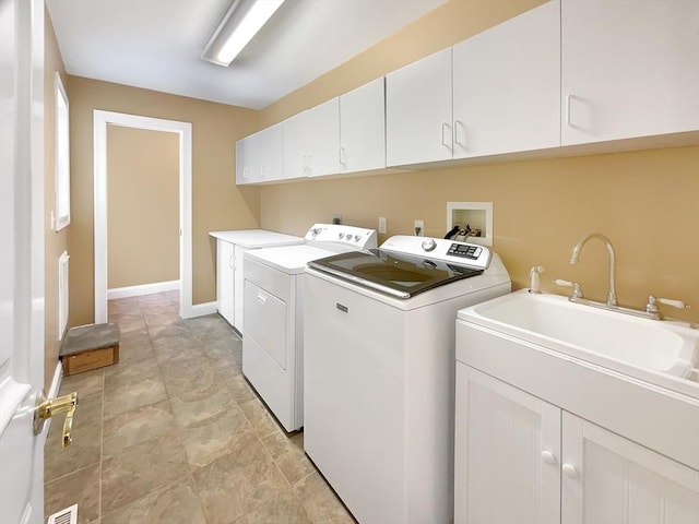 laundry area with cabinets and washing machine and clothes dryer