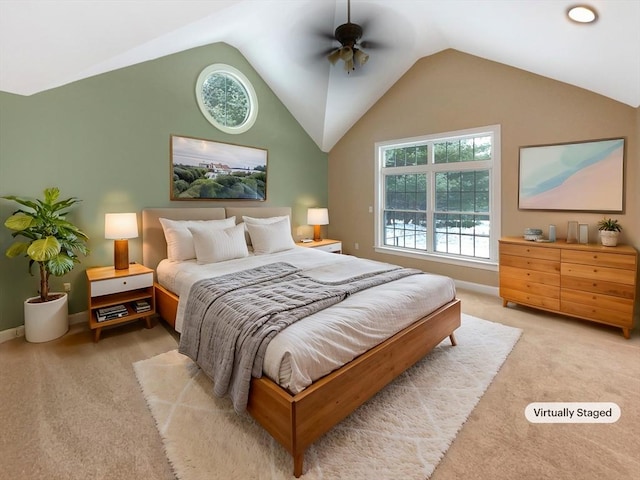 bedroom featuring ceiling fan, vaulted ceiling, and light carpet