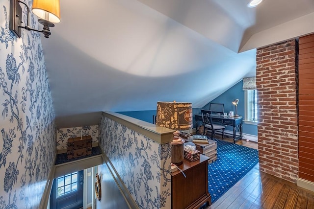 bonus room with lofted ceiling and dark hardwood / wood-style floors