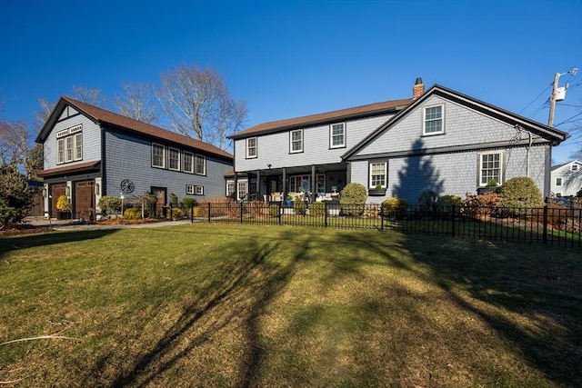 rear view of property featuring a yard