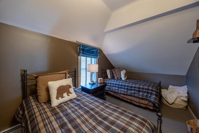 bedroom featuring baseboard heating, lofted ceiling, and carpet flooring