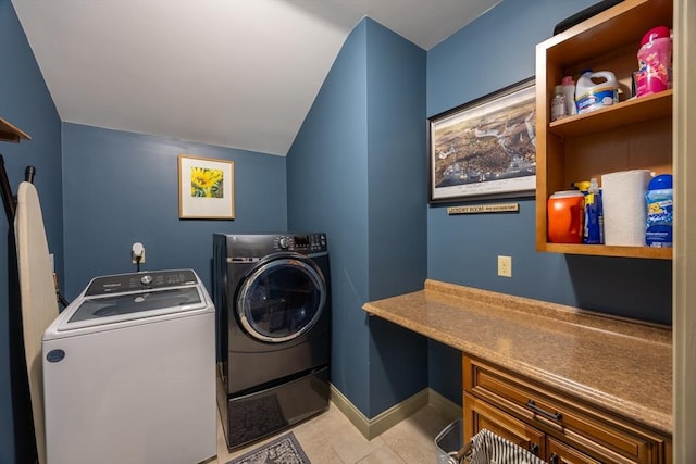 laundry room featuring washer and clothes dryer and light tile patterned flooring