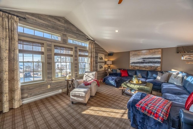 living room featuring baseboard heating, lofted ceiling, carpet floors, and wooden walls