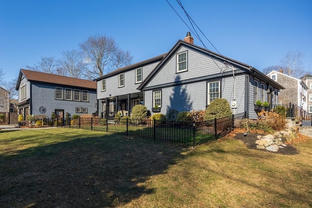 back of house with a lawn