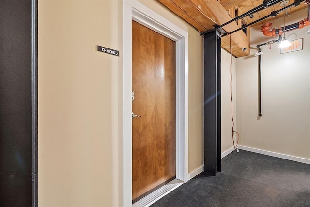 1511 Main St Unit C406, Worcester, MA 01603 - below grade area featuring dark carpet and baseboards
