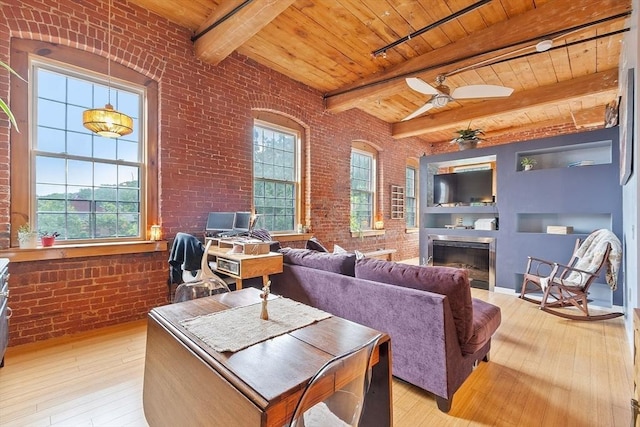 1511 Main St Unit C406, Worcester, MA 01603 - living room featuring brick wall, a wooden ceiling with exposed beams, light wood-style flooring, a fireplace, and ceiling fan