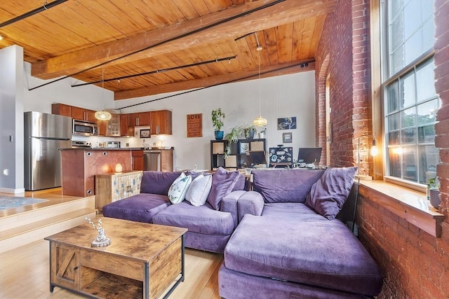 1511 Main St Unit C406, Worcester, MA 01603 - living area with a wooden ceiling with exposed beams, light wood finished floors, a high ceiling, and brick wall