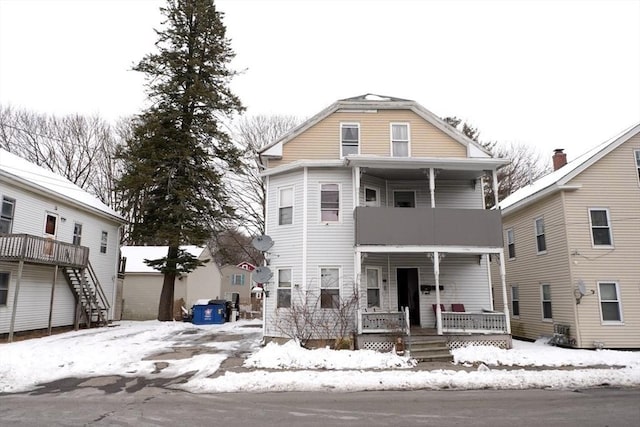 view of front of house featuring covered porch and a balcony