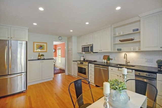 15 Edmonds Rd Unit 15, Concord, MA 01742 - kitchen with appliances with stainless steel finishes, a sink, dark countertops, light wood-style flooring, and white cabinetry