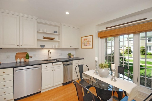 15 Edmonds Rd Unit 15, Concord, MA 01742 - kitchen with stainless steel dishwasher, a sink, dark countertops, decorative backsplash, and white cabinetry