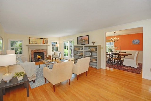 15 Edmonds Rd Unit 15, Concord, MA 01742 - living area featuring light wood-type flooring, a brick fireplace, and a chandelier