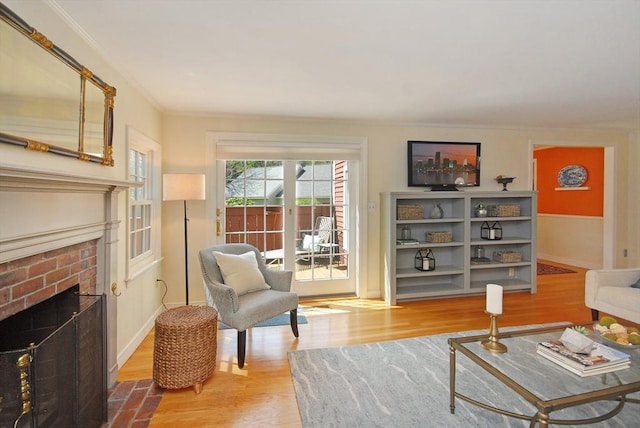 15 Edmonds Rd Unit 15, Concord, MA 01742 - living room with a brick fireplace, wood finished floors, crown molding, and baseboards