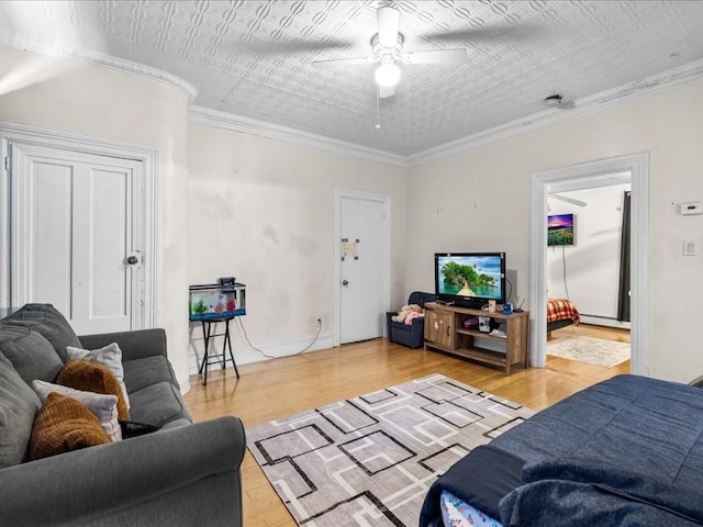 living room with light hardwood / wood-style floors, crown molding, and ceiling fan