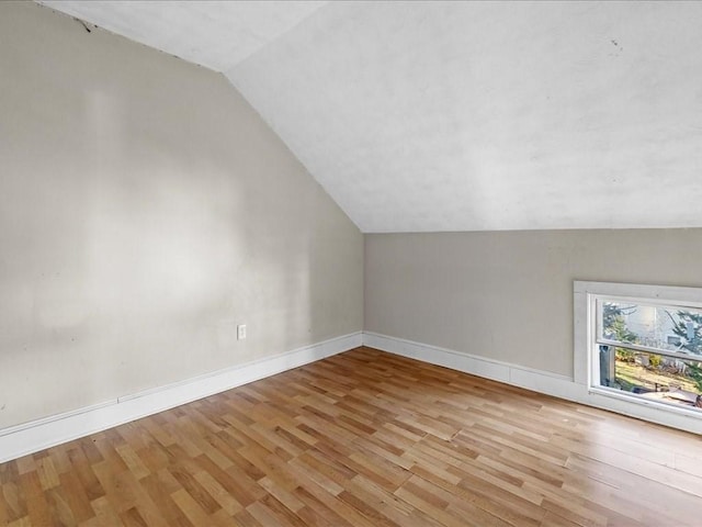 bonus room with light hardwood / wood-style flooring and lofted ceiling