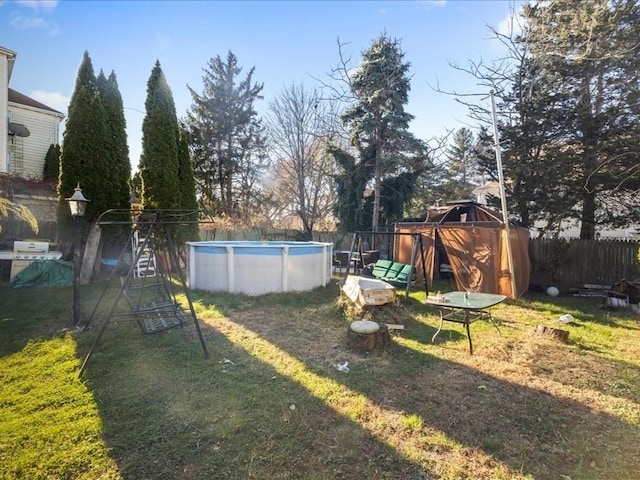 view of yard with a fenced in pool