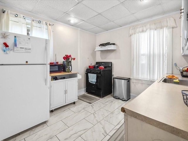 kitchen featuring sink, white cabinetry, black appliances, and a paneled ceiling