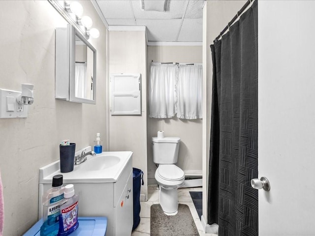 bathroom featuring a baseboard heating unit, a paneled ceiling, toilet, walk in shower, and vanity