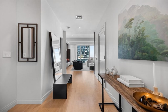 hall featuring recessed lighting, baseboards, light wood finished floors, and visible vents
