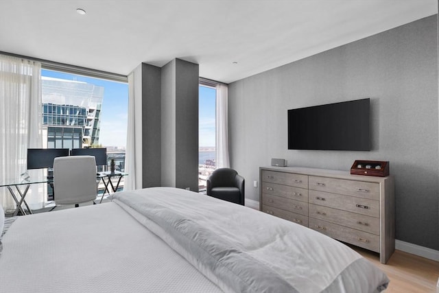 bedroom featuring baseboards and light wood-style flooring