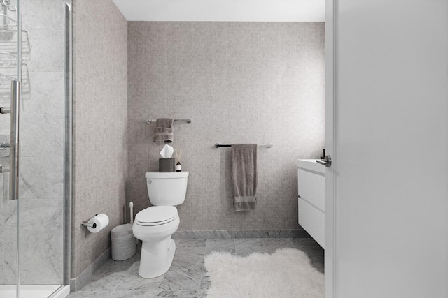 bathroom with marble finish floor, a stall shower, and toilet