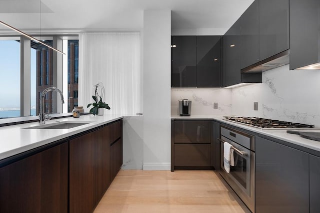 kitchen featuring stainless steel appliances, a sink, and modern cabinets