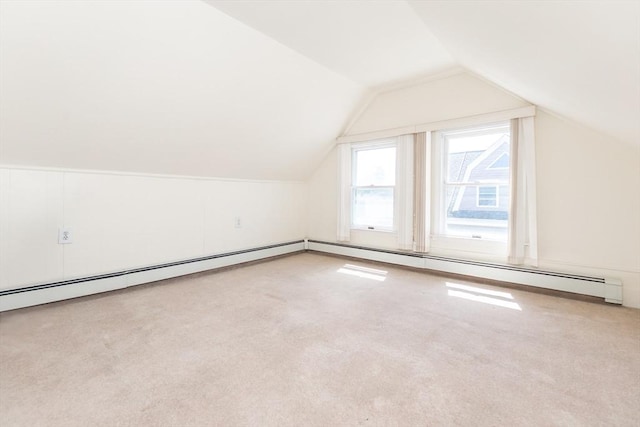 additional living space featuring vaulted ceiling and carpet