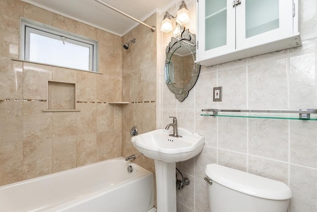bathroom featuring tile walls, tasteful backsplash, toilet, and tub / shower combination