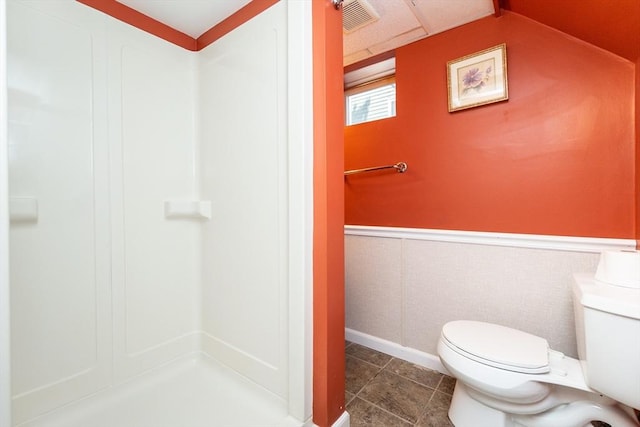 bathroom featuring visible vents, tile patterned flooring, walk in shower, a wainscoted wall, and toilet
