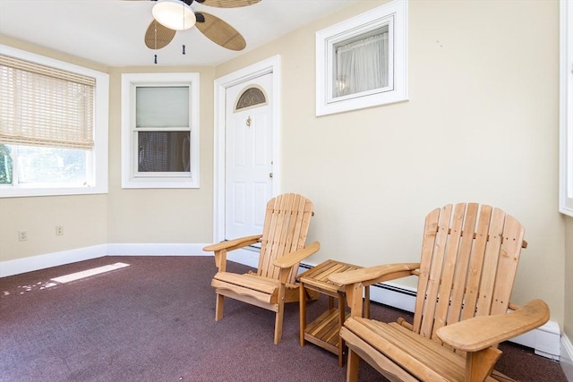 sitting room with baseboards, a ceiling fan, and carpet flooring