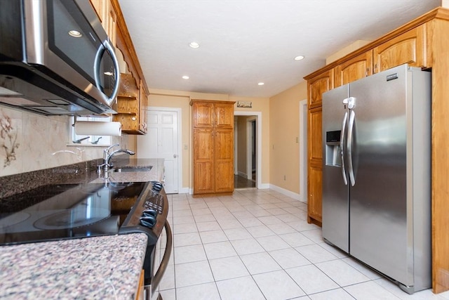 kitchen with open shelves, recessed lighting, light stone counters, a sink, and appliances with stainless steel finishes