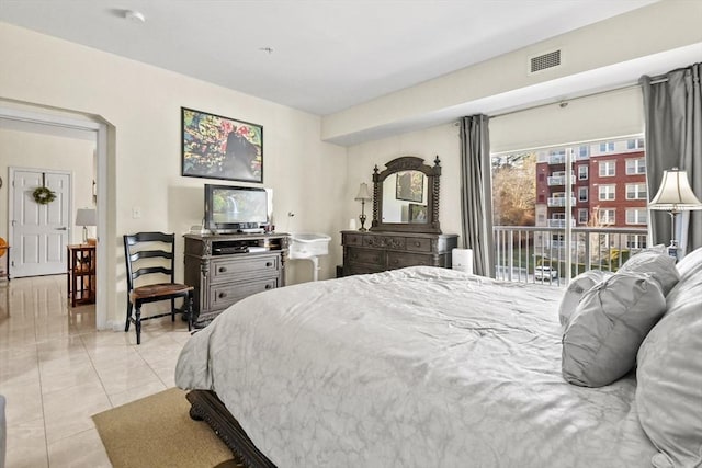 bedroom with access to exterior and light tile patterned flooring