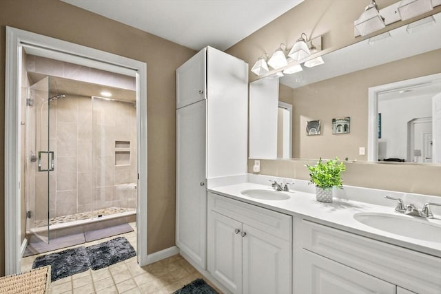 bathroom with tile patterned floors, vanity, and an enclosed shower