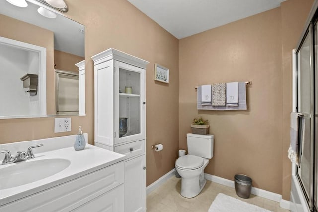 full bathroom featuring vanity, enclosed tub / shower combo, and toilet