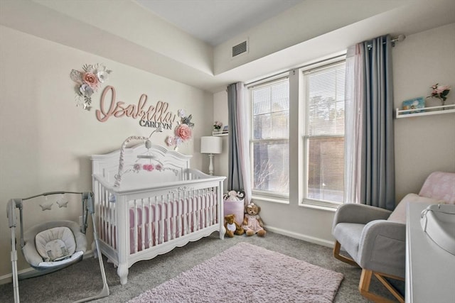 bedroom featuring carpet and a nursery area