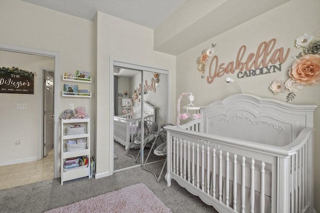 bedroom featuring carpet flooring, a closet, and a nursery area